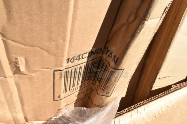 Cardboard box with visible barcode and "164CINDGRYAN" marking, indicating Lancaster Table & Seating Industrial Chair model. Box appears slightly dented.