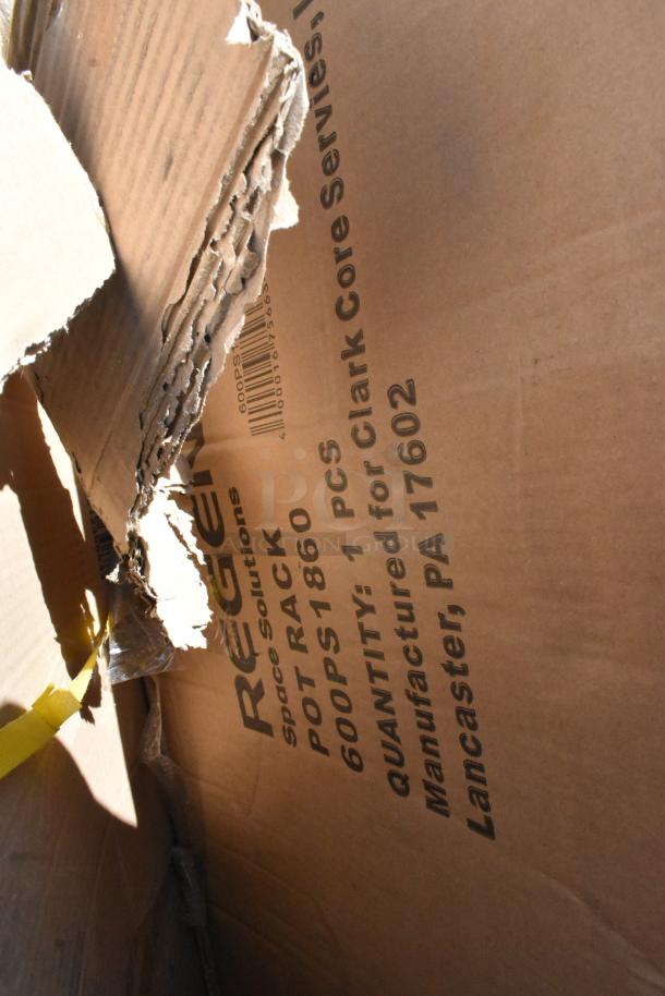 Cardboard box with visible text "Regency 600PS1860 Pot Rack, Lancaster, PA 17602" indicating manufacturer and model.