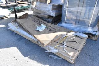 Brand new scratch and dent 600TS3696S Regency 36" x 96" stainless steel work table and 384YCZ7230 Lancaster folding table in packaging.