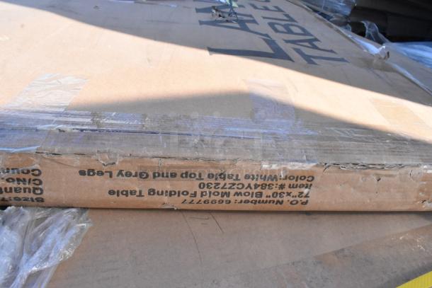 Cardboard box labeled for Lancaster Table & Seating 30" x 72" Folding Table. Box shows signs of wear.