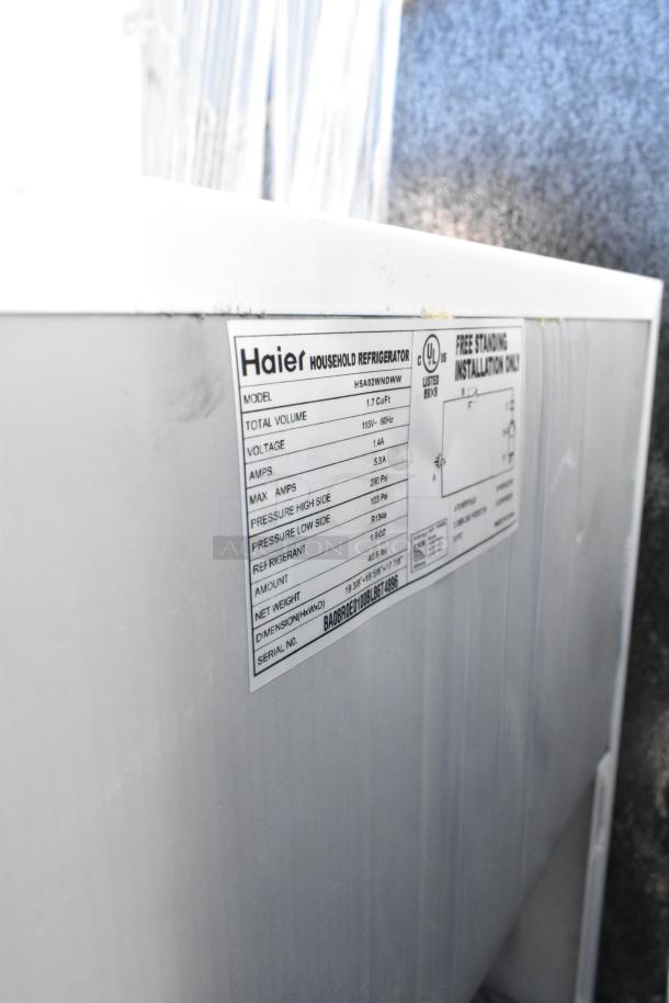 Three mini coolers, including Nostalgia IRF32BK, Haier HSA02WNDWW, 115 volts, 1 phase. Haier label shows 1.7 cu. ft. capacity.