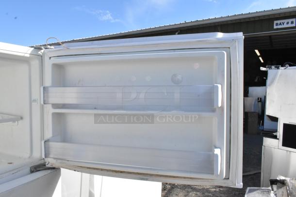 Whirlpool WRT511SZDW00 cooler with freezer, white interior, open door view, showing shelving, 115 volts, 1 phase.