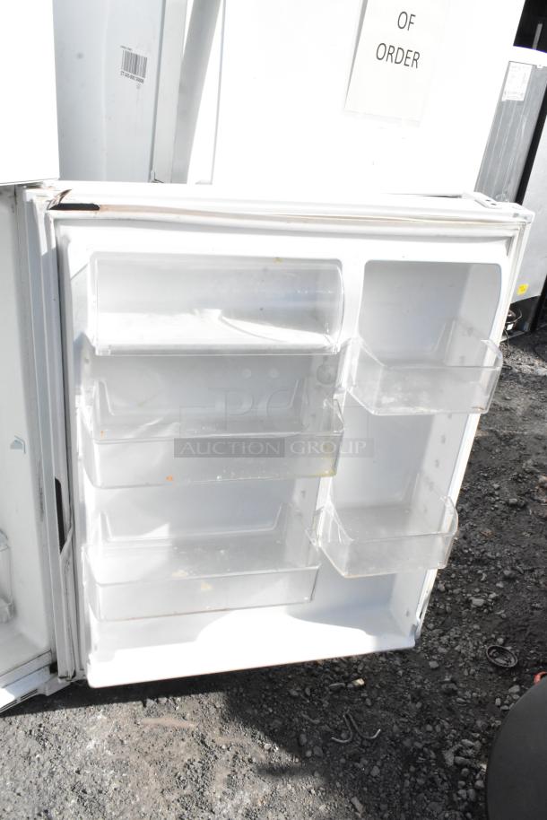Whirlpool WRT511SZDW00 cooler, white, open door with multiple clear shelves, 115V, 1 Phase, visible wear.
