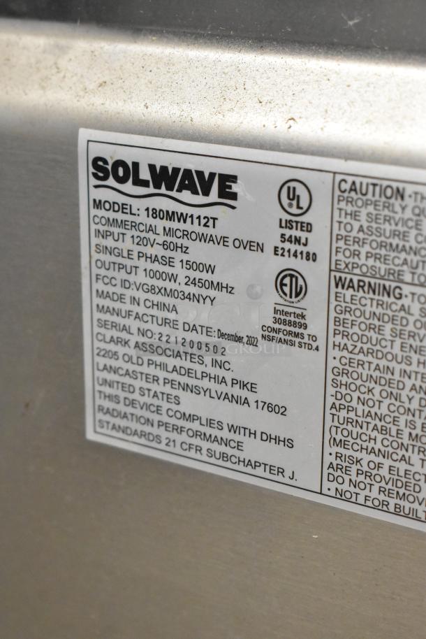 2022 Solwave 180MW112T stainless steel commercial countertop microwave oven label, detailing model, wattage, and compliance info.