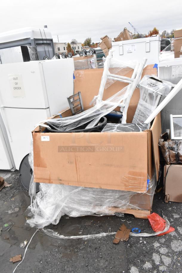 Box containing scratch and dent items, including Lancaster table tops and Lavex trash cans, with protective wrap and visible tags.