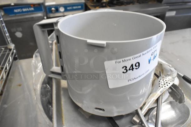 Lot of various kitchen items including a gray food processor bowl, metal baking pan, and utensils. Marked with auction tag #349.