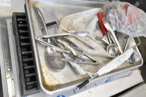 Lot of various kitchen items including metal baking pan, assorted utensils, and food processor bowl. Used condition.