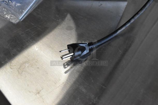 Image of a Bunn VPR-APS coffee brewer power cord on a metal surface, highlighting the scratch and dent condition.