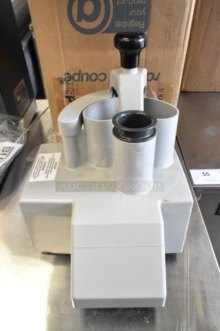 Brand new Robot Coupe 27213 food processor with minor scratches and dents. Visible caution label on the unit.