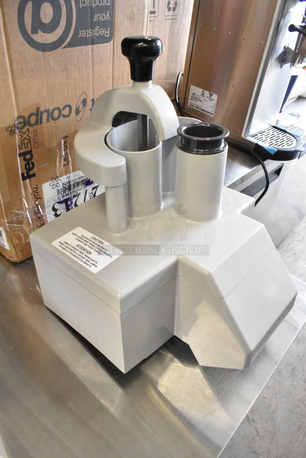 Brand new Robot Coupe 27213 food processor with minor scratches, featuring durable gray finish and caution label visible.