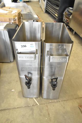 Two brand new scratch and dent stainless steel beverage dispensers with spouts, labeled "Fetco," in warehouse setting.