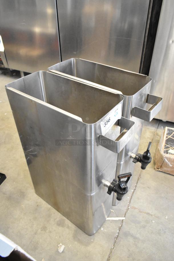 Pair of stainless steel beverage dispensers, new with scratches and dents, featuring handles and spouts. Quantity tag visible.