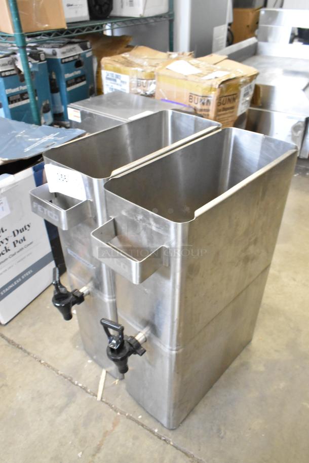 Two new stainless steel beverage dispensers, scratch and dent condition, featuring FETCO branding and black spigots.