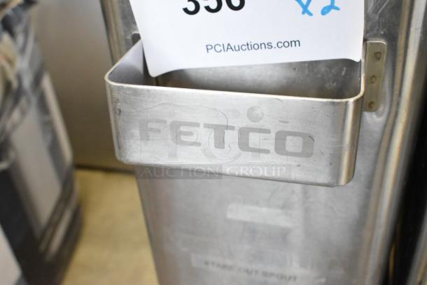Stainless steel Fetco beverage holder dispenser with minor scratches, brand new condition, auctioned at PCI Auctions.