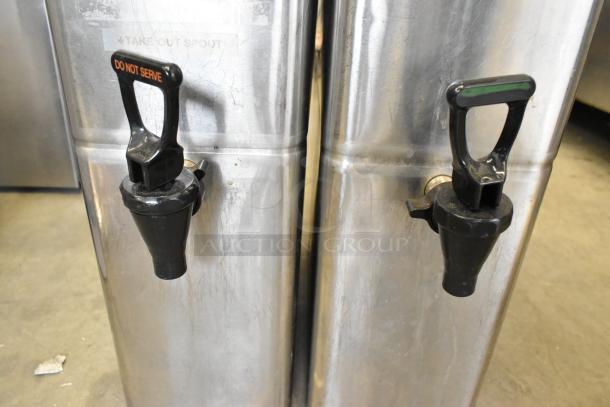 Brand new stainless steel beverage holders with minor dents, featuring black spouts labeled "Do Not Serve."