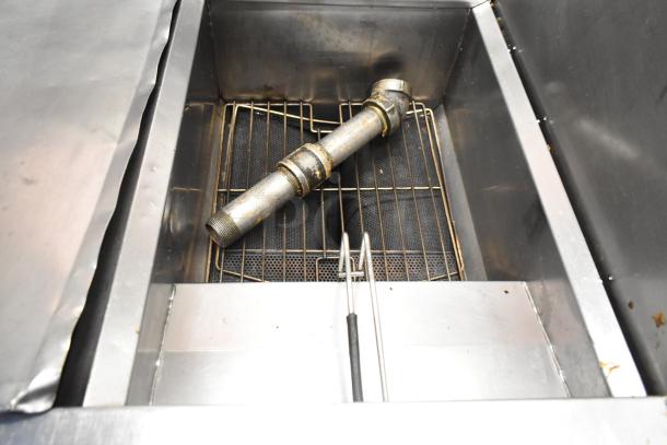 Frymaster PH255SC stainless steel commercial deep fryer with grate inside, natural gas, 80,000 BTU, on casters, used condition.