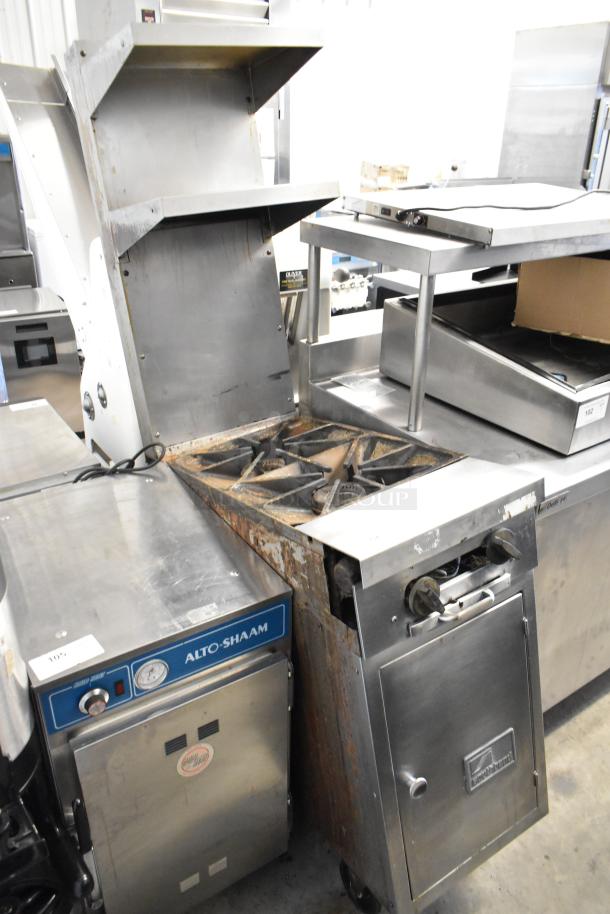 Southbend stainless steel 2-burner commercial gas range, with 2-tier overshelf, backsplash, and casters, showing wear.
