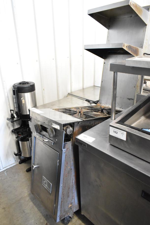 Southbend stainless steel 2-burner range with 2-tier over shelf and backsplash on commercial casters. Natural gas, used condition.