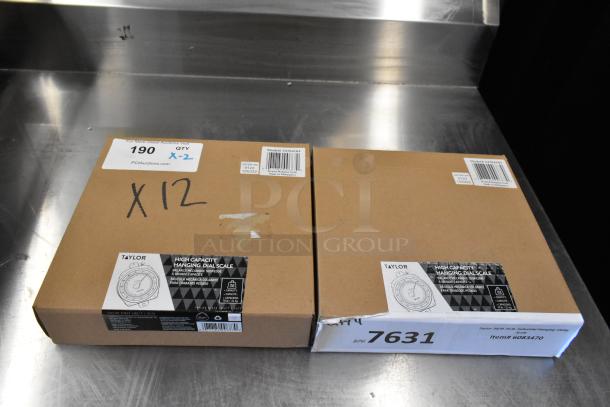 Two brand new Taylor High Capacity Hanging Digital Scales, model 6083470, in original packaging. Scratch and dent condition.