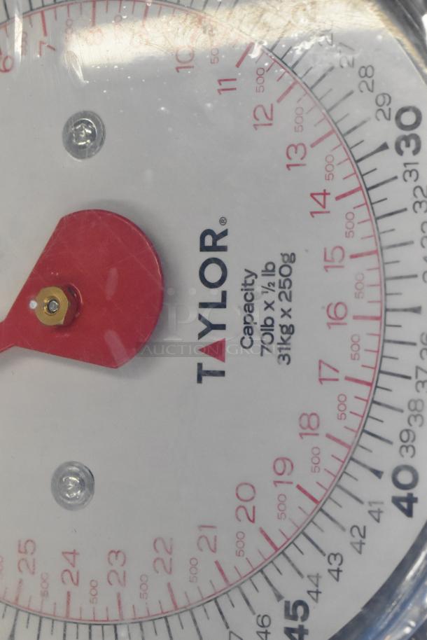 Brand new Taylor high capacity hanging digital scale, model 6083470. Capacity: 70 lb/31 kg. Visible label and settings.