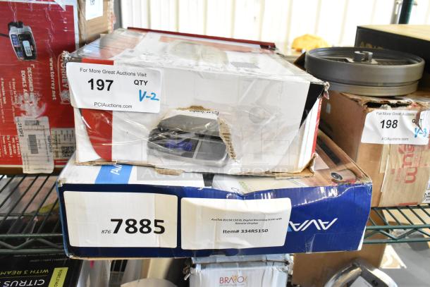 Two brand new digital scales in original packaging, 334RS150 AvaTek 150 lb. with remote display, and San Jamar / Escali 33 lb. kitchen scale. Boxes show minor wear.