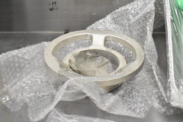 Brand new Assure 190M22HGA meat grinder attachment for #22 hub, with minor scratches and dents, in packaging.