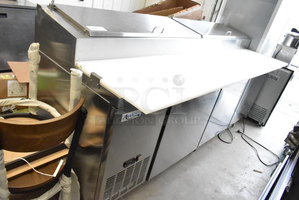 Brand new Avantco 178SSPPT3 stainless steel pizza prep table with scratches and dents, commercial casters, 115V, 1 phase.