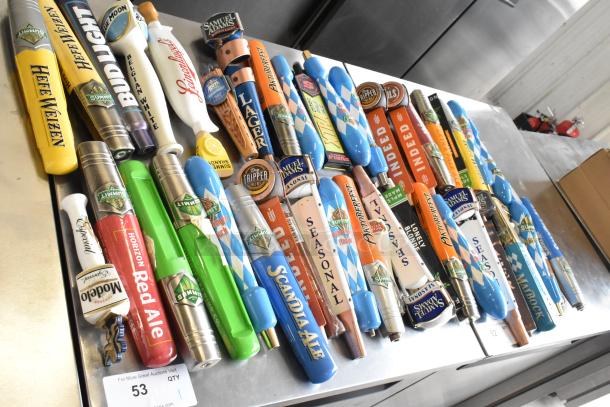 44 assorted beer tap handles featuring brands like Blue Moon, Oktoberfest, and Surly Brewing Co., in excellent condition.