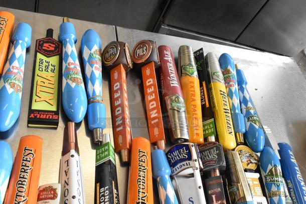 44 assorted beer tap handles including Blue Moon, Surly Brewing Co., Oktoberfest. Various styles, good condition.