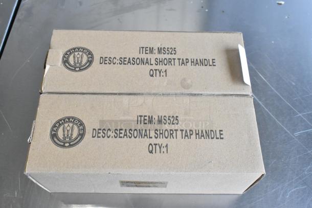 Box of 9 brand new tap handles, including MS525 model. "Seasonal Short Tap Handle" marked on packaging.