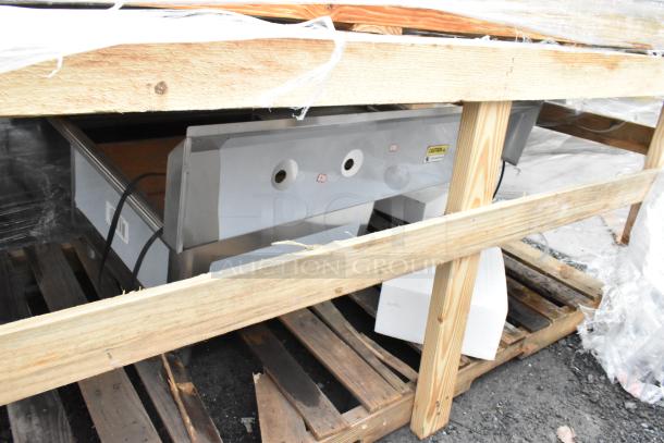 Brand new Regency 600S1232324L stainless steel sink with left drain board, visible crate packaging, some scratches and dents.