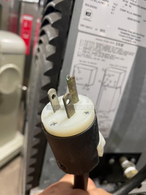 Manitowoc IY0454A-161 commercial ice machine plug and label close-up. 115V, Energy Star certified, air-cooled, on legs.