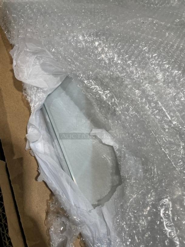 Omcan 60" refrigerated display case, model RSCN0471S. Stainless steel, New-Scratch-N-Dent condition. On casters, partially wrapped.