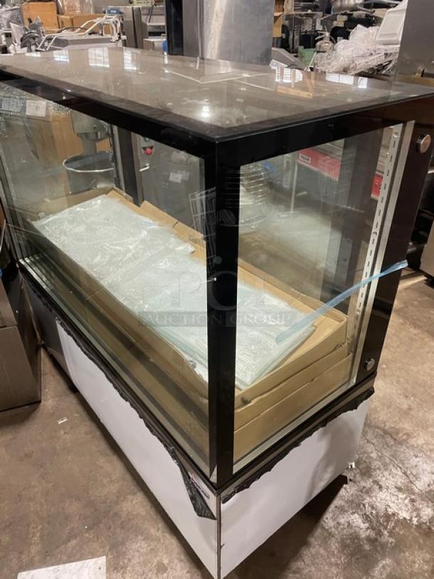 Omcan stainless steel 60" bakery display case, model RSCN0471S, with straight glass, multi-tier shelving, on casters.