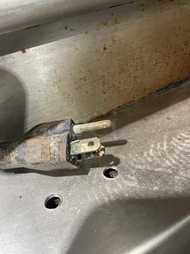 Vulcan commercial stainless steel tilt braising pan plug, showing slight corrosion. Natural gas powered, ultra tilt skillet.