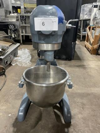 Hobart commercial planetary mixer with mixing bowl, heavy-duty, electric-powered, on legs, visible auction label.