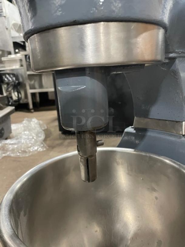 Hobart commercial electric planetary mixer with stainless steel bowl, mounted on legs. Heavy-duty, ideal for professional kitchens.