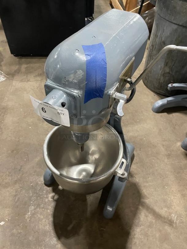 Hobart commercial heavy-duty planetary mixer with mixing bowl, on legs; used condition with visible wear and tape marking.