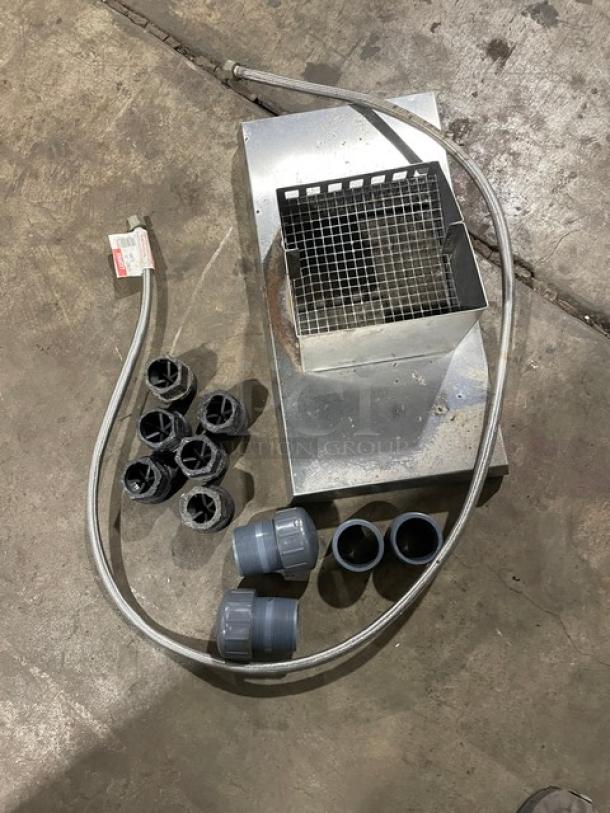 Metal vent cover with cable and connectors on a concrete floor. Accessories include six black star-shaped inserts and four gray couplers.