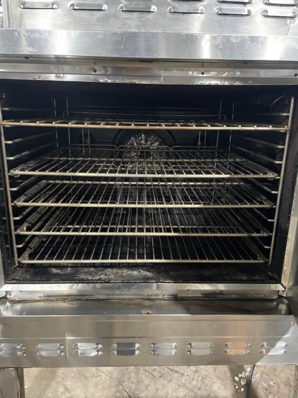 Blodgett commercial stainless steel natural gas convection oven with wired rack, single stack, on legs, showing interior.