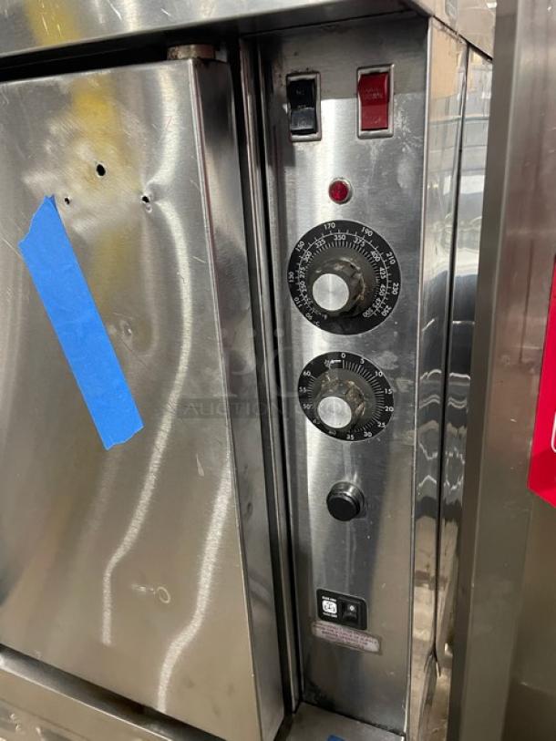 Blodgett stainless steel natural gas convection oven, single stack, with wired rack, temperature dials, and timer on legs.