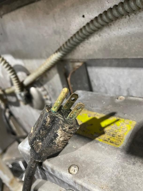 Blodgett commercial stainless steel convection oven power plug, showing signs of wear and corrosion. Dirt accumulation visible.
