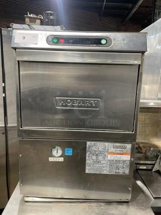 Hobart LXi Series stainless steel undercounter dishwasher, Energy Star certified, electric-powered, with control panel and safety labels.