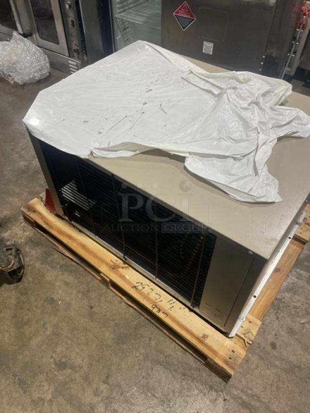 Heatcraft CZT025M6D condensing unit on pallet, covered partially with plastic. Model and serial number visible. 460V, 3-phase.
