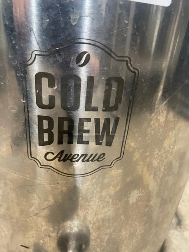 Cold Brew Avenue stainless steel countertop cold brew coffee maker with cover and handles, visible logo.