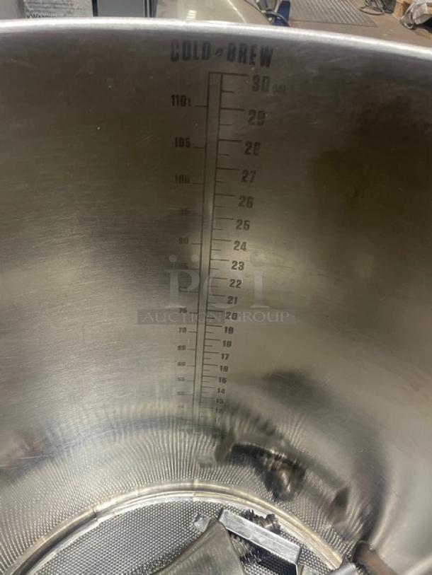 Cold Brew Avenue stainless steel countertop cold brew coffee maker, features measurement markings, cover, and handles.