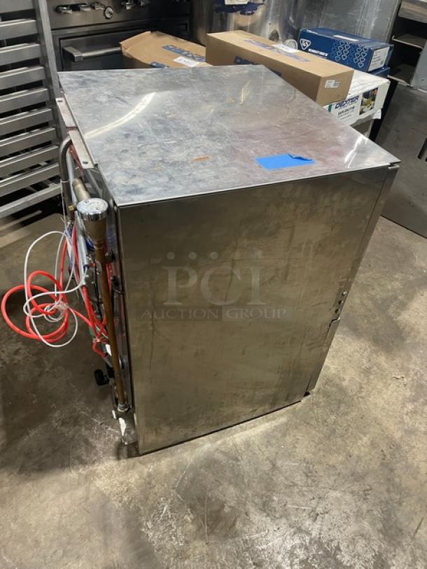 Jackson DishStar Series stainless steel electric high-temperature undercounter dishwasher, model DISHSTARHT. Includes full-size peg rack, visible plumbing connections, and serial number 19H378197. Condition appears used.