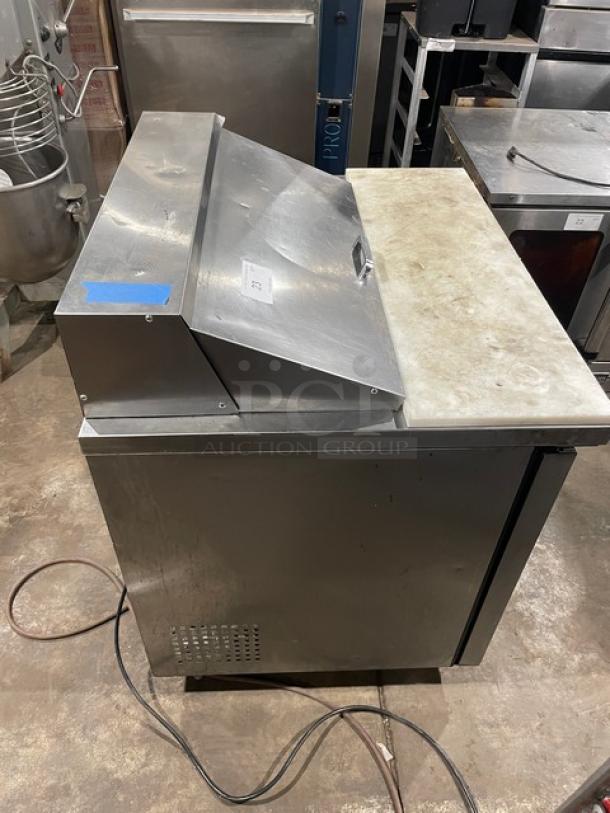 True TSSU-36-08 stainless steel prep table with cutting board, pans, poly-coated rack. Two doors, on casters. Model TSSU3608.