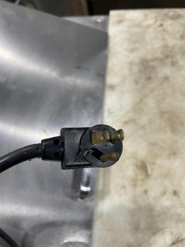 Three-prong power plug of True TSSU-3608 commercial refrigerated prep table, 115V, suitable for salad or sandwich preparation.