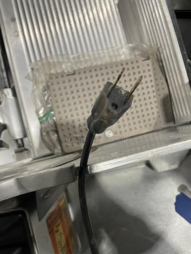 Bizerba commercial electric countertop deli meat slicer on legs, features black power cord, appears in used condition.